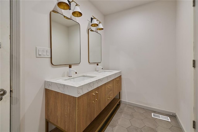 918 W 32nd Ter, Kansas City, MO 64111 - bathroom with double vanity, baseboards, and tile patterned flooring