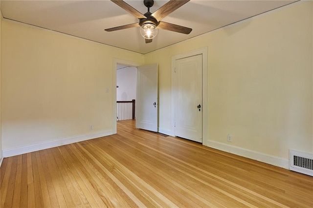 918 W 32nd Ter, Kansas City, MO 64111 - empty room with a ceiling fan, baseboards, and light wood-style flooring
