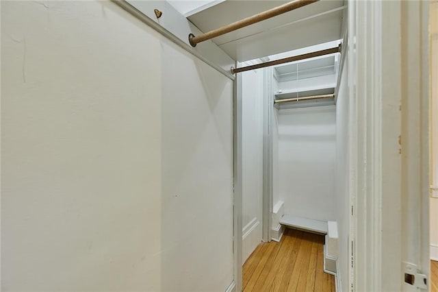918 W 32nd Ter, Kansas City, MO 64111 - walk in closet with light wood-type flooring