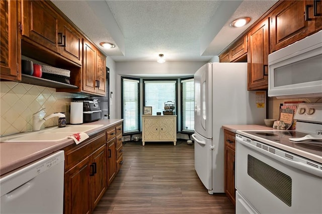 1007 SE 3rd St, Lees Summit, MO 64063 - kitchen with white appliances, a sink, decorative backsplash, a textured ceiling, and light countertops