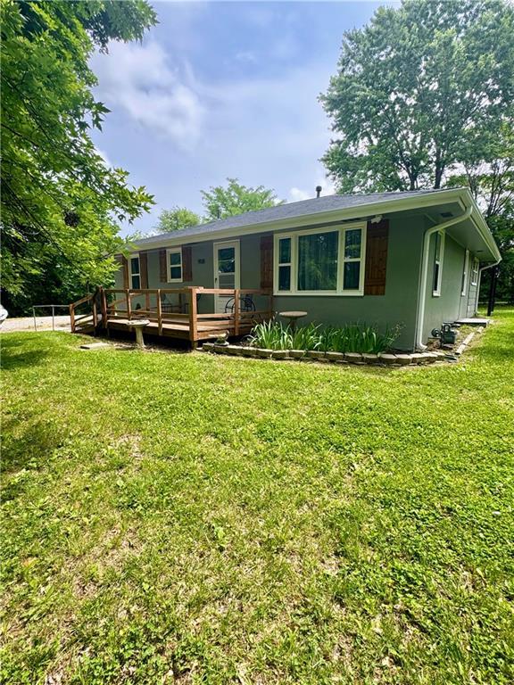 908 N 8th St, Lansing, KS 66043 - back of property featuring a wooden deck and a yard
