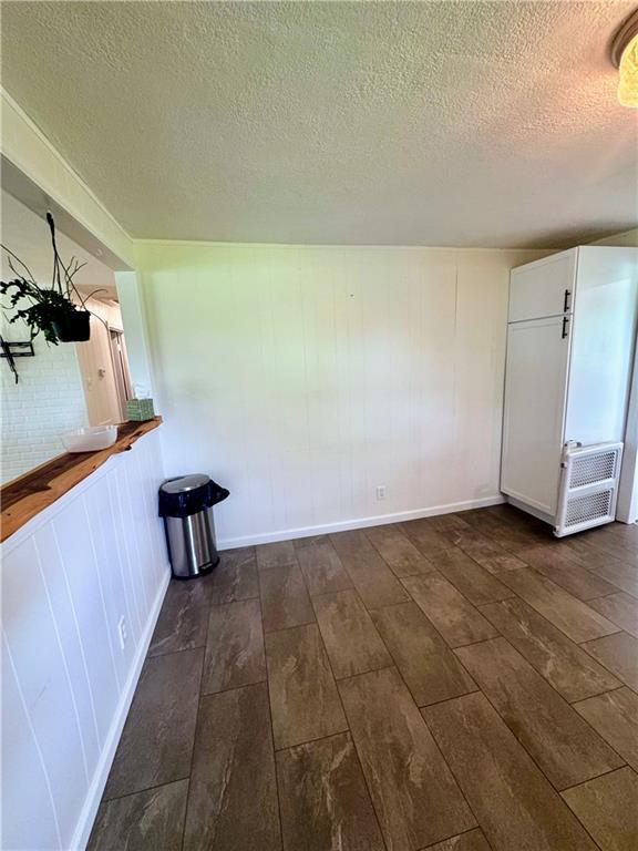 908 N 8th St, Lansing, KS 66043 - unfurnished room featuring dark wood finished floors and a textured ceiling