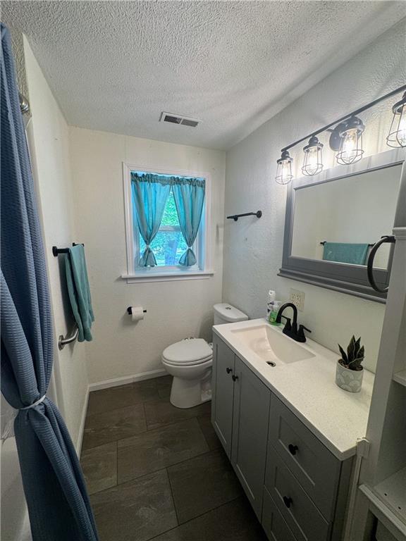 908 N 8th St, Lansing, KS 66043 - bathroom with vanity and a textured ceiling