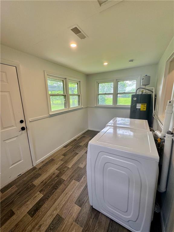 908 N 8th St, Lansing, KS 66043 - washroom with electric water heater, washer and dryer, dark wood-style floors, plenty of natural light, and recessed lighting