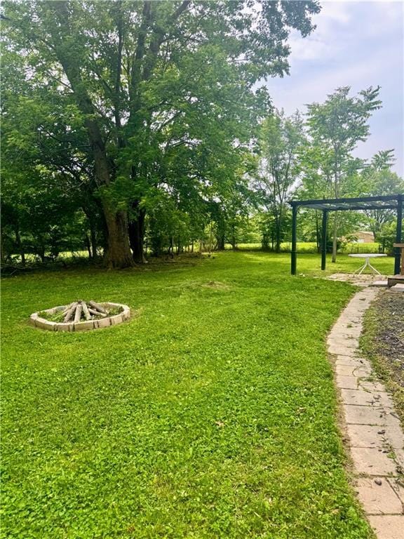 908 N 8th St, Lansing, KS 66043 - view of grassy yard with an outdoor fire pit