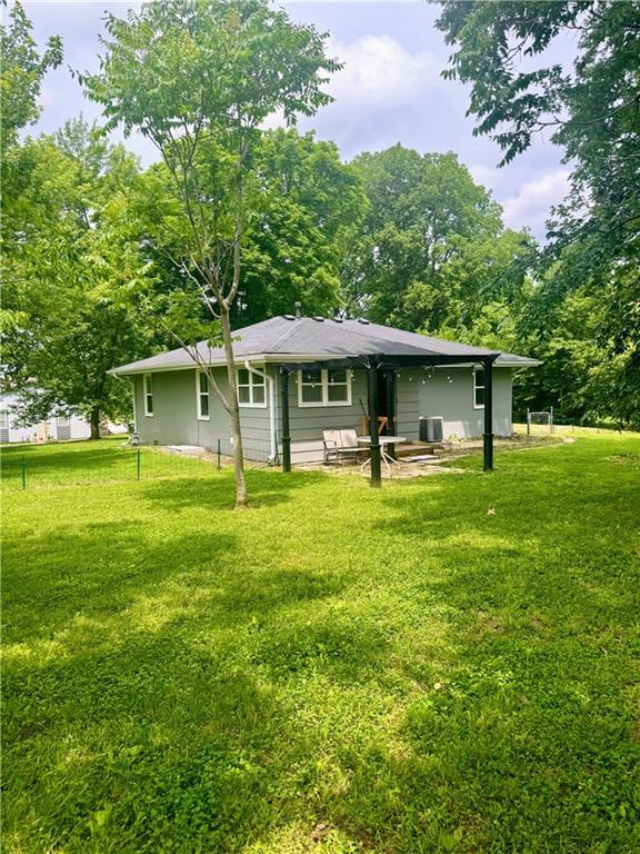 908 N 8th St, Lansing, KS 66043 - rear view of property with a yard and a patio area