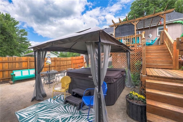 208 N Ohio St, Archie, MO 64725 - deck featuring a hot tub, a gazebo, outdoor dining area, a fenced backyard, and a patio area