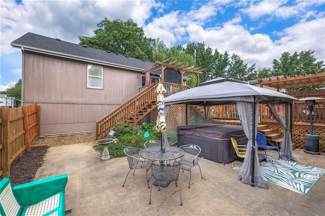 208 N Ohio St, Archie, MO 64725 - view of patio with a hot tub, stairs, a gazebo, a pergola, and outdoor dining area