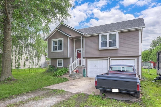 208 N Ohio St, Archie, MO 64725 - bi-level home featuring concrete driveway, a garage, and a shingled roof