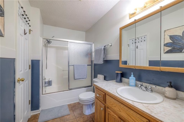 208 N Ohio St, Archie, MO 64725 - full bath with vanity, toilet, a textured ceiling, bath / shower combo with glass door, and tile patterned floors