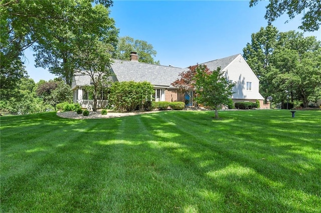 1908 Pine Ridge Dr, Leavenworth, KS 66048 - obstructed view of property with a front lawn and a chimney