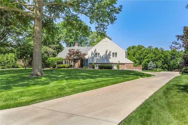 1908 Pine Ridge Dr, Leavenworth, KS 66048 - view of front of house with a chimney and a front yard