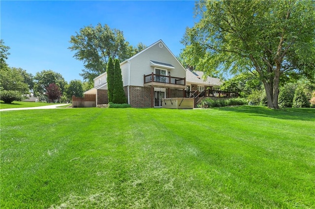 1908 Pine Ridge Dr, Leavenworth, KS 66048 - rear view of house with brick siding, a hot tub, a lawn, and a deck