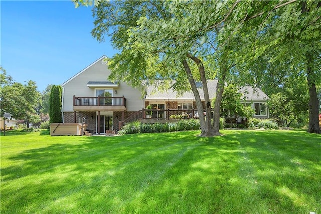 1908 Pine Ridge Dr, Leavenworth, KS 66048 - rear view of property featuring a hot tub, a deck, a yard, and brick siding