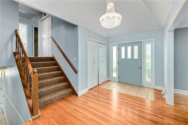1908 Pine Ridge Dr, Leavenworth, KS 66048 - entrance foyer featuring a chandelier, wood finished floors, and stairs