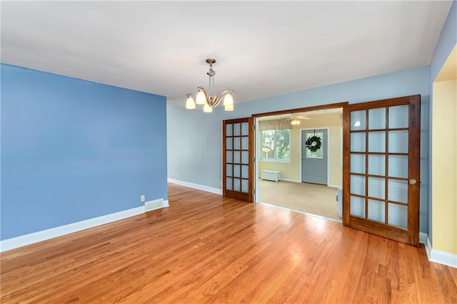 1908 Pine Ridge Dr, Leavenworth, KS 66048 - spare room with light wood-type flooring and a chandelier