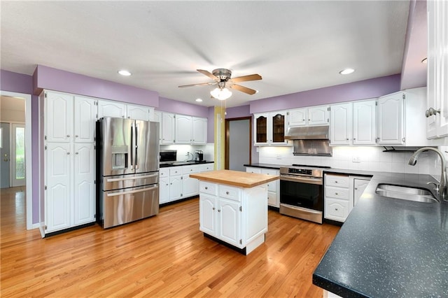 1908 Pine Ridge Dr, Leavenworth, KS 66048 - kitchen featuring stainless steel appliances, under cabinet range hood, butcher block counters, a ceiling fan, and backsplash