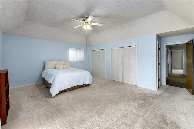 1908 Pine Ridge Dr, Leavenworth, KS 66048 - carpeted bedroom featuring two closets, a tray ceiling, a ceiling fan, and a textured ceiling
