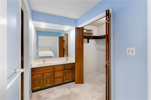1908 Pine Ridge Dr, Leavenworth, KS 66048 - full bath featuring double vanity, a textured ceiling, ensuite bath, and a spacious closet
