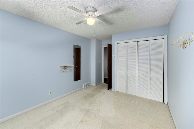 1908 Pine Ridge Dr, Leavenworth, KS 66048 - unfurnished bedroom featuring carpet flooring, a closet, a textured ceiling, and a ceiling fan