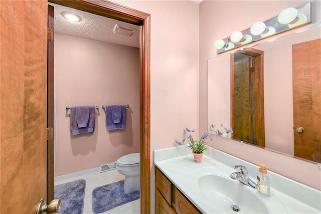 1908 Pine Ridge Dr, Leavenworth, KS 66048 - bathroom featuring vanity, a textured ceiling, and tile patterned flooring
