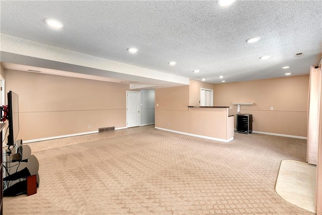 1908 Pine Ridge Dr, Leavenworth, KS 66048 - unfurnished living room featuring light colored carpet, recessed lighting, and a textured ceiling