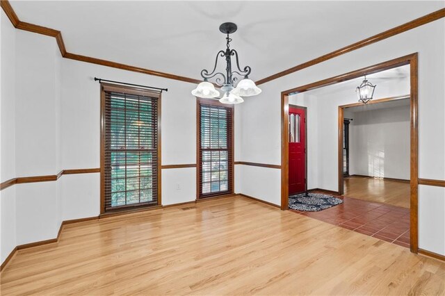 8541 Oakview Dr, Lenexa, KS 66215 - unfurnished room with a chandelier, light wood-style floors, and ornamental molding