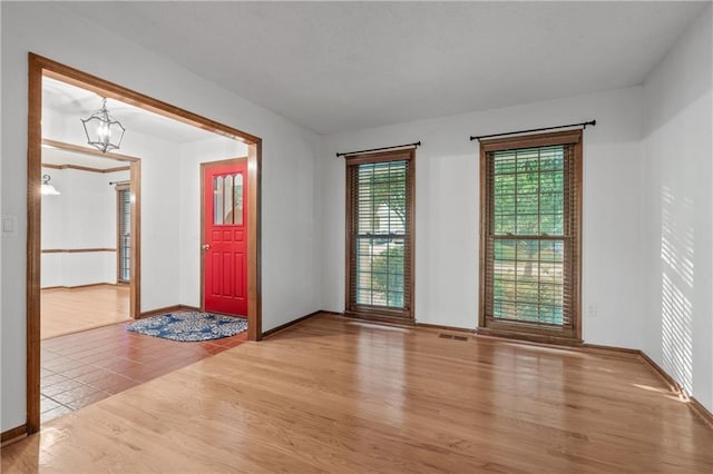 8541 Oakview Dr, Lenexa, KS 66215 - entrance foyer featuring light wood-type flooring and a chandelier