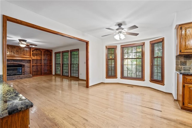 8541 Oakview Dr, Lenexa, KS 66215 - unfurnished living room featuring ceiling fan, light wood finished floors, and a fireplace