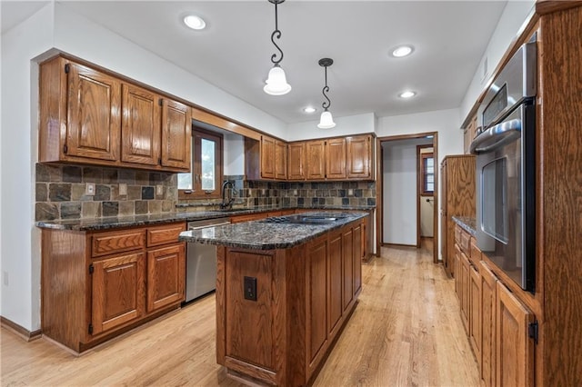8541 Oakview Dr, Lenexa, KS 66215 - kitchen with stainless steel appliances, a center island, light wood-style flooring, brown cabinetry, and recessed lighting