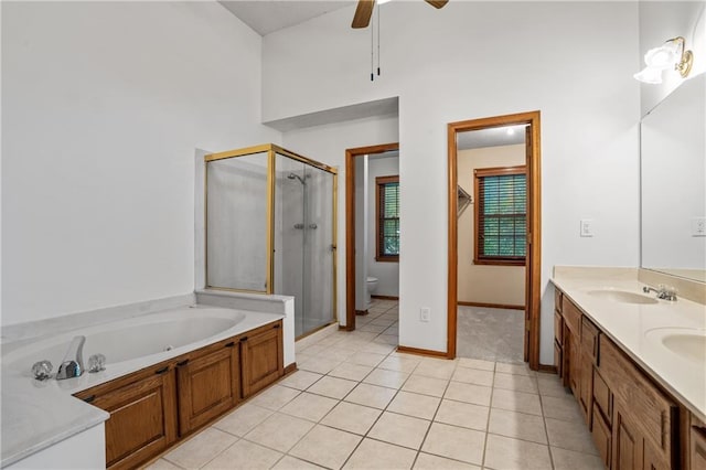 8541 Oakview Dr, Lenexa, KS 66215 - full bathroom with a stall shower, double vanity, tile patterned floors, a bath, and ceiling fan