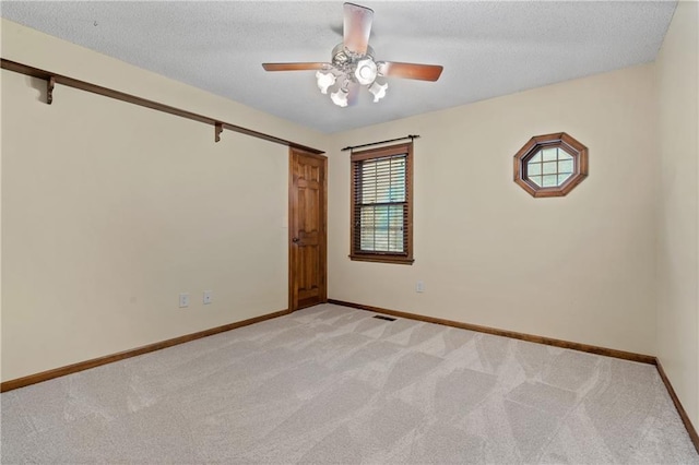 8541 Oakview Dr, Lenexa, KS 66215 - spare room featuring light carpet, ceiling fan, and a textured ceiling