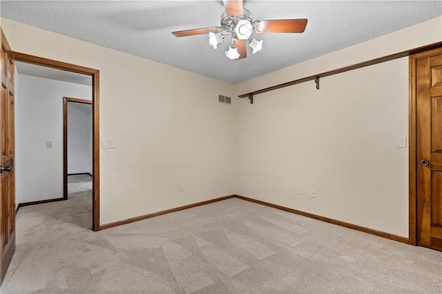8541 Oakview Dr, Lenexa, KS 66215 - empty room with light carpet, ceiling fan, and a textured ceiling