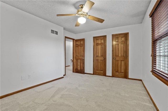 8541 Oakview Dr, Lenexa, KS 66215 - unfurnished bedroom with carpet floors, a textured ceiling, and a ceiling fan