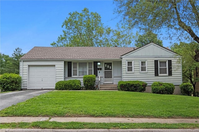 3501 N Delaware St, Independence, MO 64050 - single story home featuring an attached garage, board and batten siding, asphalt driveway, a front yard, and covered porch
