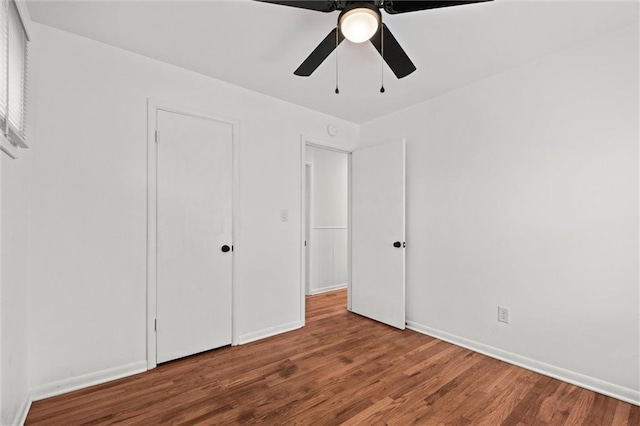 3501 N Delaware St, Independence, MO 64050 - unfurnished bedroom with wood finished floors, baseboards, and a ceiling fan