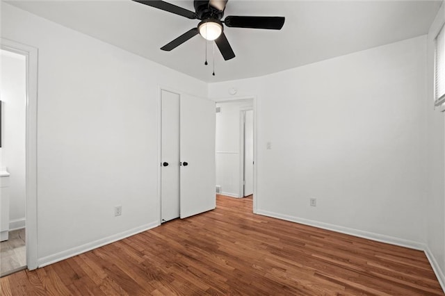 3501 N Delaware St, Independence, MO 64050 - unfurnished bedroom featuring wood finished floors, baseboards, a ceiling fan, and ensuite bath