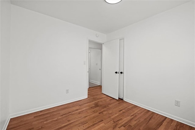 3501 N Delaware St, Independence, MO 64050 - spare room featuring wood finished floors and baseboards