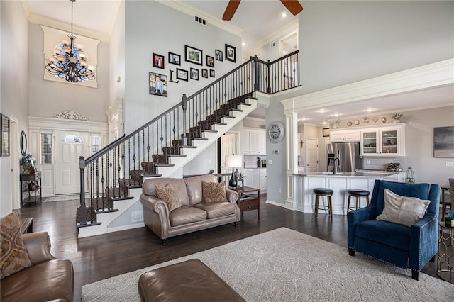4307 N 110th Ter, Kansas City, KS 66109 - living area featuring a high ceiling, stairs, dark wood-style flooring, crown molding, and a chandelier