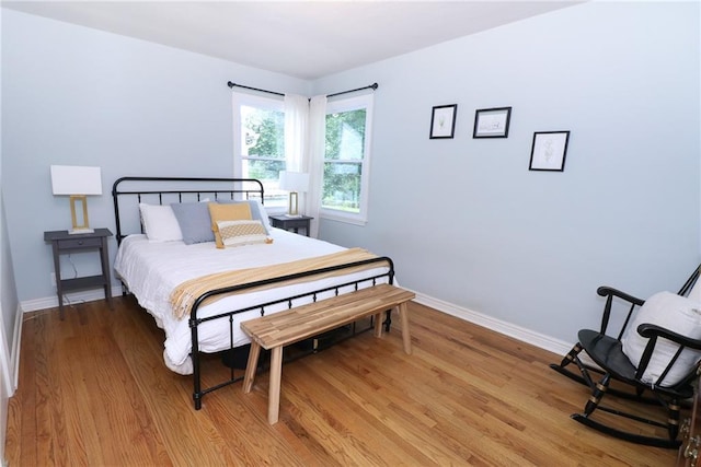 5904 N Howard Ave, Gladstone, MO 64118 - bedroom with light wood-style flooring and baseboards