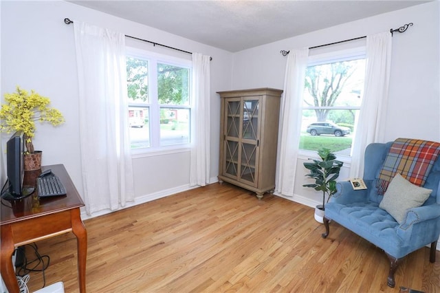 5904 N Howard Ave, Gladstone, MO 64118 - living area with light wood-style floors, baseboards, and healthy amount of natural light