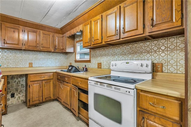 39135 Plum Creek Rd, Osawatomie, KS 66064 - kitchen with white electric stove, light countertops, brown cabinets, and backsplash