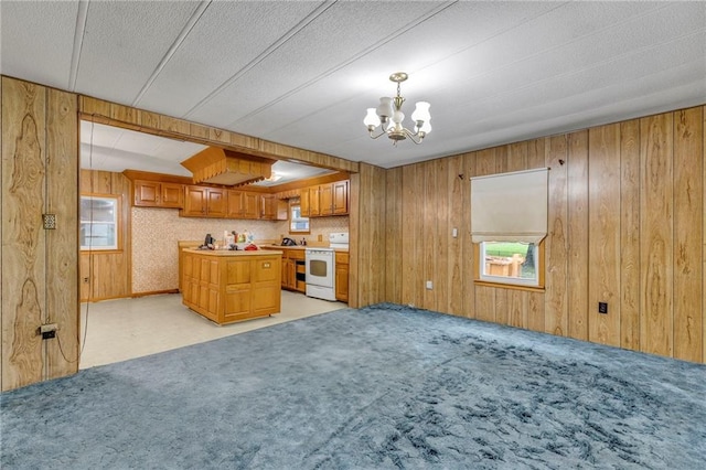 39135 Plum Creek Rd, Osawatomie, KS 66064 - kitchen with white range with electric stovetop, a chandelier, brown cabinetry, light countertops, and wooden walls