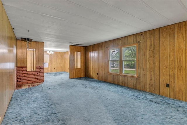 39135 Plum Creek Rd, Osawatomie, KS 66064 - unfurnished room featuring carpet floors, wood walls, and a chandelier
