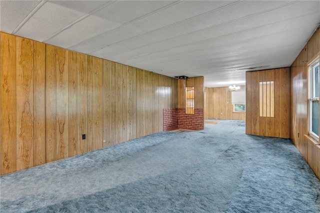 39135 Plum Creek Rd, Osawatomie, KS 66064 - carpeted spare room featuring wood walls and a chandelier