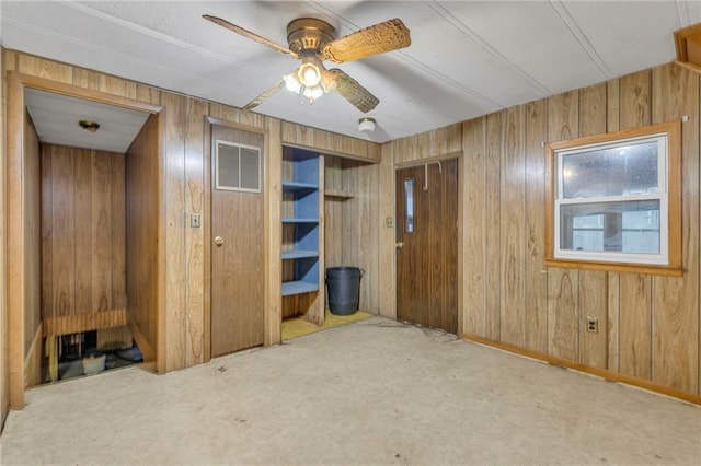 39135 Plum Creek Rd, Osawatomie, KS 66064 - carpeted empty room featuring a ceiling fan and wood walls