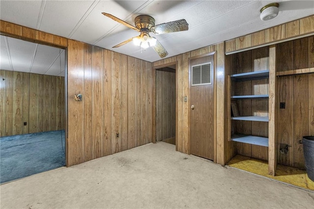 39135 Plum Creek Rd, Osawatomie, KS 66064 - basement featuring wood walls, a ceiling fan, and carpet flooring