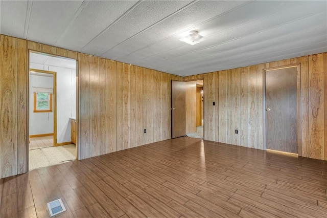 39135 Plum Creek Rd, Osawatomie, KS 66064 - empty room with wooden walls and wood finished floors