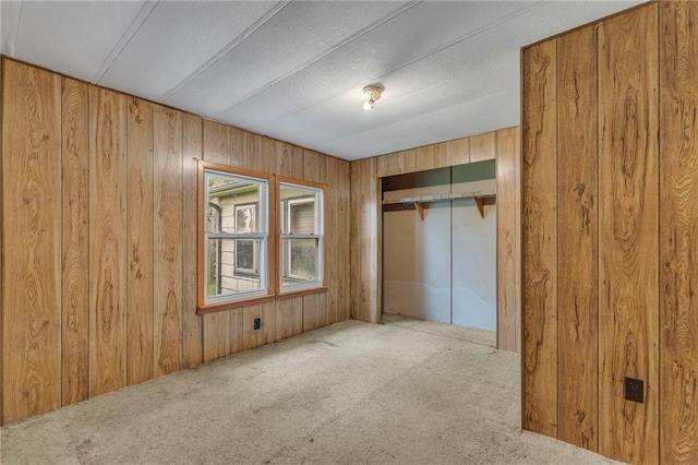 39135 Plum Creek Rd, Osawatomie, KS 66064 - unfurnished bedroom with wood walls, carpet, a closet, and elevator