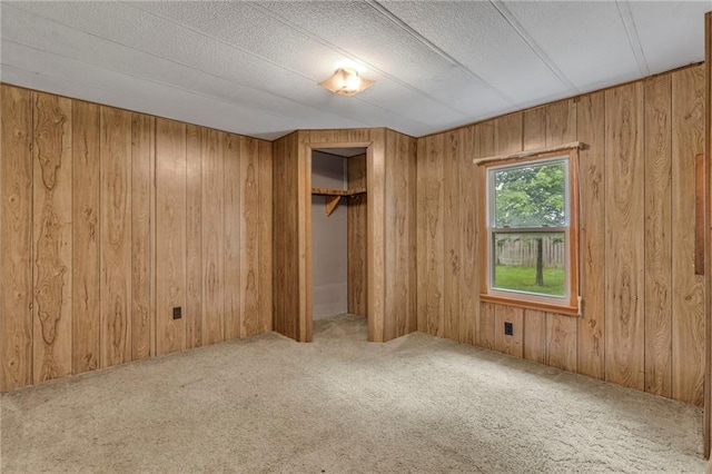 39135 Plum Creek Rd, Osawatomie, KS 66064 - unfurnished bedroom featuring a closet, carpet, and wooden walls
